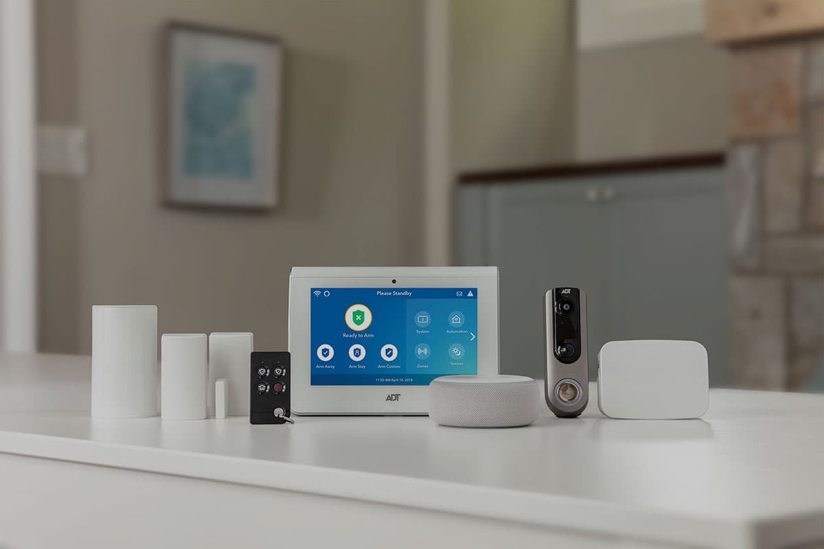 ADT Command panel, sensors, video doorbell and smart speaker on a home surface